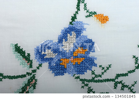 Vintage handmade floral cross-stitch embroidery and lace on white linen Vintage handmade floral cross-stitch embroidery and lace on white linen 134501845