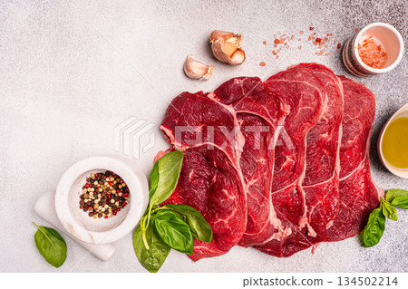 Raw organic steak with ingredients for cooking Raw organic steak with ingredients for cooking 134502214