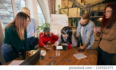 Diverse coworkers discussing ideas during office meeting Diverse coworkers discussing ideas during office meeting 134502375