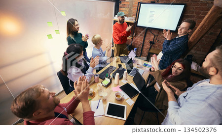 Team collaboration around table in modern coworking office. Team collaboration around table in modern coworking office. 134502376