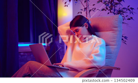 Young woman tired while working on laptop at home 134502409