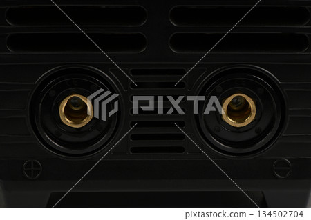 Close-up of welding machine front panel sockets and vents Close-up of welding machine front panel sockets and vents 134502704