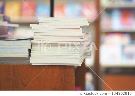 Books stacked on a table in a quiet store hallway 134502913