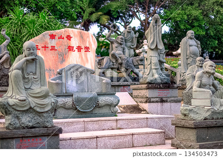 Stone sculptures of Buddhist monks in Nanshan Park, China. General view, daytime, summer Stone sculptures of Buddhist monks in Nanshan Park, China. General view, daytime, summer 134503473