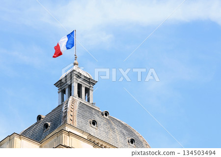 French flag on the dome of the Palais du Luxembourg in Paris against the sky 134503494