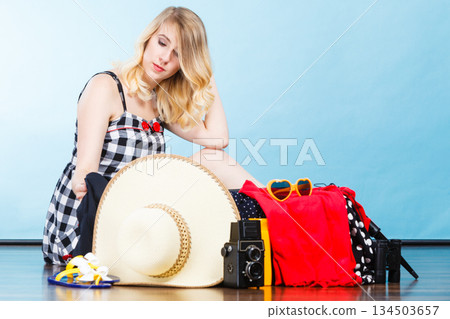Young woman packing suitcase 134503657