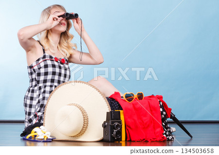 Young woman packing suitcase 134503658