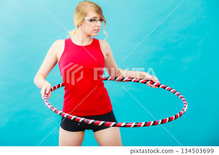 Fit woman with hula hoop doing exercise Fit woman with hula hoop doing exercise 134503699