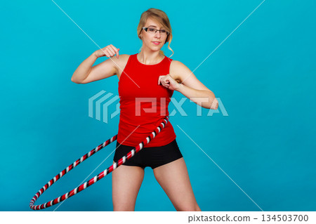 Fit woman with hula hoop doing exercise Fit woman with hula hoop doing exercise 134503700