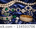 Luxury Jewelry Collection with Diamonds, Emeralds, and Sapphires on Blue Silk 134503706