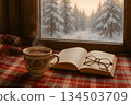 Cozy Winter Scene with Hot Coffee and Book by a Window 134503709
