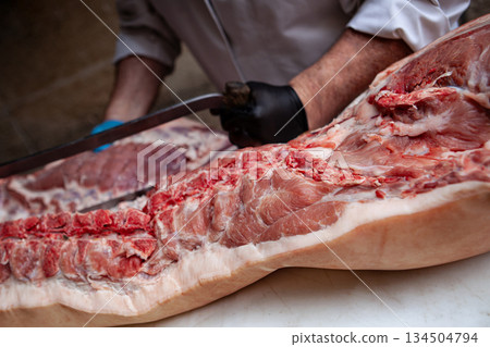 Preparing pork ribs in the butcher shop Preparing pork ribs in the butcher shop 134504794