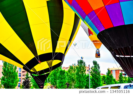 Colorful hot air balloon flying over blue sky with white clouds Colorful hot air balloon flying over blue sky with white clouds 134505116
