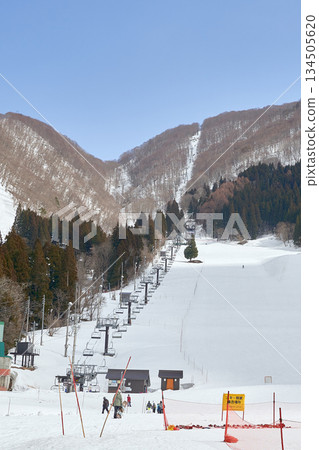 Winter ski resort and snowy mountain scenery with lifts 134505620