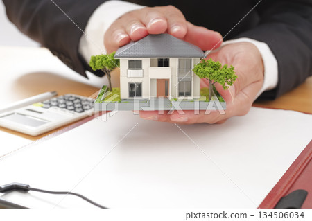 Businessman holding a real estate model 134506034