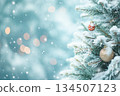 Snow-covered fir tree and ornament background 134507123