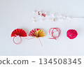 Red and gold fans and mizuhiki New Year's decorations lined up on a white background 134508345