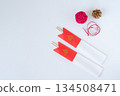 Celebratory chopsticks in a red and white chopstick bag and New Year's decorations 134508471