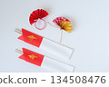 Celebratory chopsticks in a red and white chopstick bag and New Year's decorations 134508476