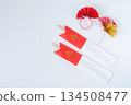 Celebratory chopsticks in a red and white chopstick bag and New Year's decorations 134508477