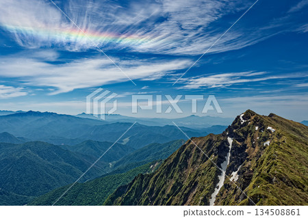 Mt. Tanigawa and iridescent clouds seen from Mt. Ichinokura in early summer Mt. Tanigawa and iridescent clouds seen from Mt. Ichinokura in early summer 134508861