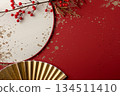 Product photography with a gold fan and branches on a red background 134511410