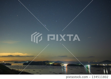 A beautiful winter starry sky over the sea in Setouchi City, Okayama Prefecture, Japan A beautiful winter starry sky over the sea in Setouchi City, Okayama Prefecture, Japan 134511802