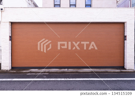 A closeup shot of automatic metal roller door used in factory, storage, garage, and industrial warehouse. The corrugated and foldable metal sheet offer space saving and provide urban and rustic feel A closeup shot of automatic metal roller door used in factory, storage, garage, and industrial warehouse. The corrugated and foldable metal sheet offer space saving and provide urban and rustic feel 134515109