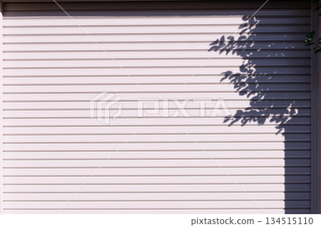 A closeup shot of automatic metal roller door used in factory, storage, garage, and industrial warehouse. The corrugated and foldable metal sheet offer space saving and provide urban and rustic feel 134515110