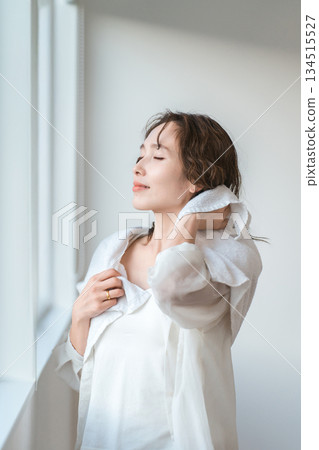 An Asian woman who towel-dries her hair after taking a bath and shampooing in the morning An Asian woman who towel-dries her hair after taking a bath and shampooing in the morning 134515527