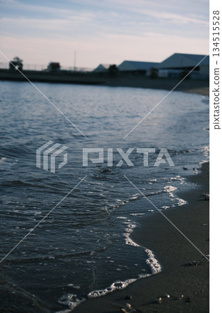 Dusk in an industrial area. The boundary between the water surface and the sandy beach Dusk in an industrial area. The boundary between the water surface and the sandy beach 134515528