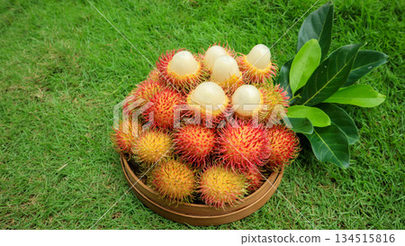 Peeled rambutan sweet showing white flesh, ripe rambutan fruit in basket, tropical organic fruit Peeled rambutan sweet showing white flesh, ripe rambutan fruit in basket, tropical organic fruit 134515816