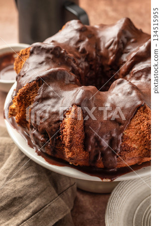 Chocolate marble bundt cake or zebra cake with chocolate glaze on brown table background close up Chocolate marble bundt cake or zebra cake with chocolate glaze on brown table background close up 134515955