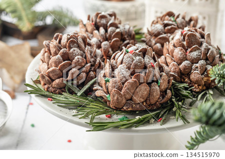 Christmas pine cones cakes, sweet and tasty holiday Christmas and New Year homemade dessert on white tile kitchen table Christmas pine cones cakes, sweet and tasty holiday Christmas and New Year homemade dessert on white tile kitchen table 134515970