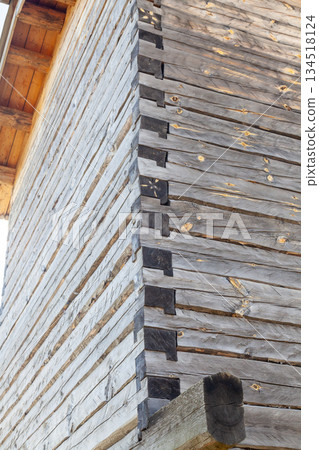 Wooden log cabin corner joinery lap joint close up 134518124