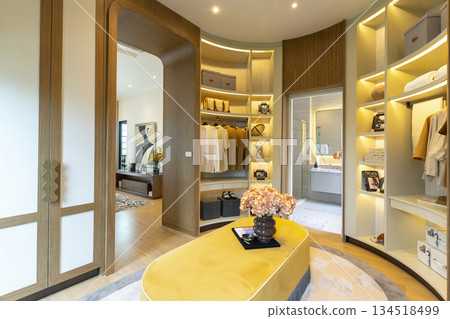 Interior view of huge walk-in closet of a luxury bedroom. 134518499