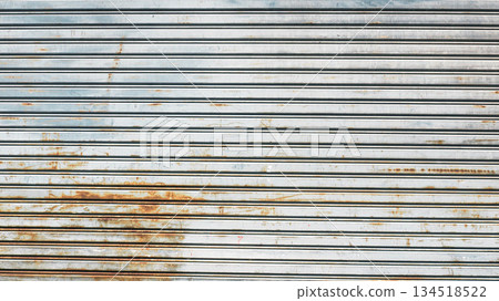 Old rusty metal roller shutter door texture, Horizontal lines of weathered iron garage door. 134518522