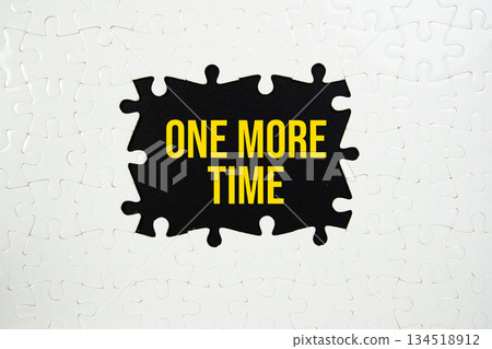 Jigsaw puzzle with a missing piece with "One More Time" on yellow background Jigsaw puzzle with a missing piece with "One More Time" on yellow background 134518912