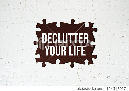 Jigsaw puzzle with a missing piece with "Declutter Your Life" on brown background 134518917