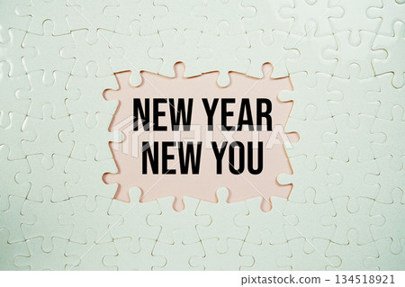Jigsaw puzzle with a missing piece with "New Year New You" on pink background 134518921