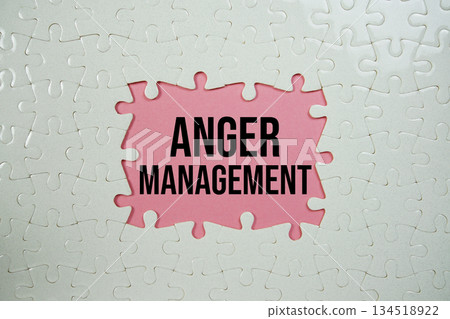 Jigsaw puzzle with a missing piece with "Anger Management" on pink background 134518922