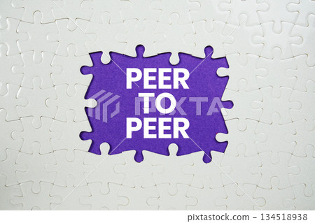 Jigsaw puzzle with a missing piece with "Peer to Peer" on purple background 134518938