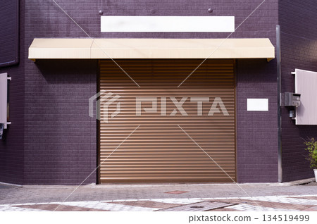 A closeup shot of automatic metal roller door used in factory, storage, garage, and industrial warehouse. The corrugated and foldable metal sheet offer space saving and provide urban and rustic feel A closeup shot of automatic metal roller door used in factory, storage, garage, and industrial warehouse. The corrugated and foldable metal sheet offer space saving and provide urban and rustic feel 134519499