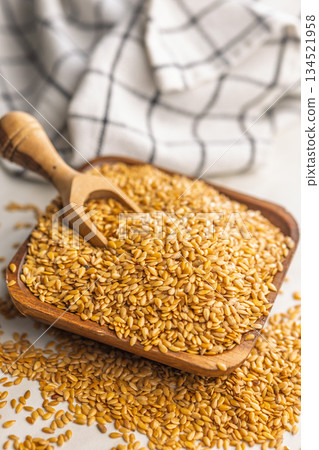Golden linseed or flaxseed. Healthy flax seed in bowl on kitchen table. Golden linseed or flaxseed. Healthy flax seed in bowl on kitchen table. 134521958