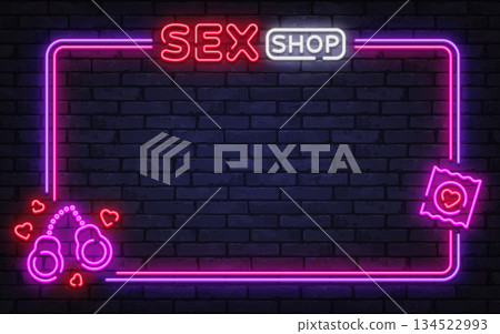 Bright neon vector frame with sex shop sign, handcuffs, and condom icon. Perfect for adult store promotion, bold window signage, and nightlife branding. Bright neon vector frame with sex shop sign, handcuffs, and condom icon. Perfect for adult store promotion, bold window signage, and nightlife branding. 134522993