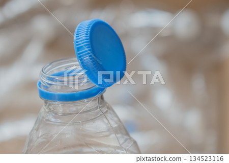 close up of innovative attached cap on empty pet bottle, merging convenience with ecology close up of innovative attached cap on empty pet bottle, merging convenience with ecology 134523116