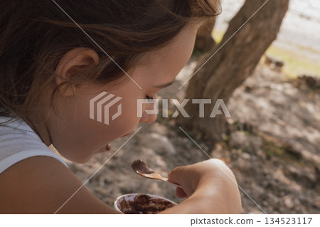 Simple summer joy: child enjoying a scoop of ice cream on a sunny day 134523117