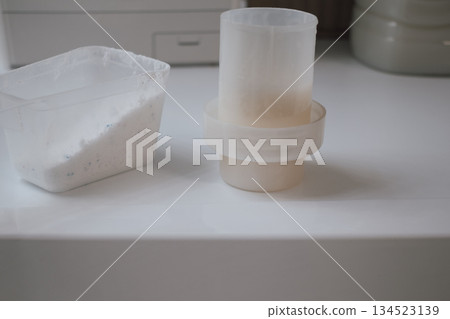 washing powder in scoop and liquid softener in cap: essential laundry chemicals washing powder in scoop and liquid softener in cap: essential laundry chemicals 134523139