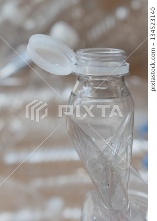 close up of innovative attached cap on empty pet bottle, merging convenience with ecology 134523140