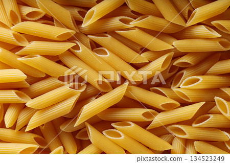 Dry Yellow Penne Pasta Background Italian Cuisine Concept 134523249